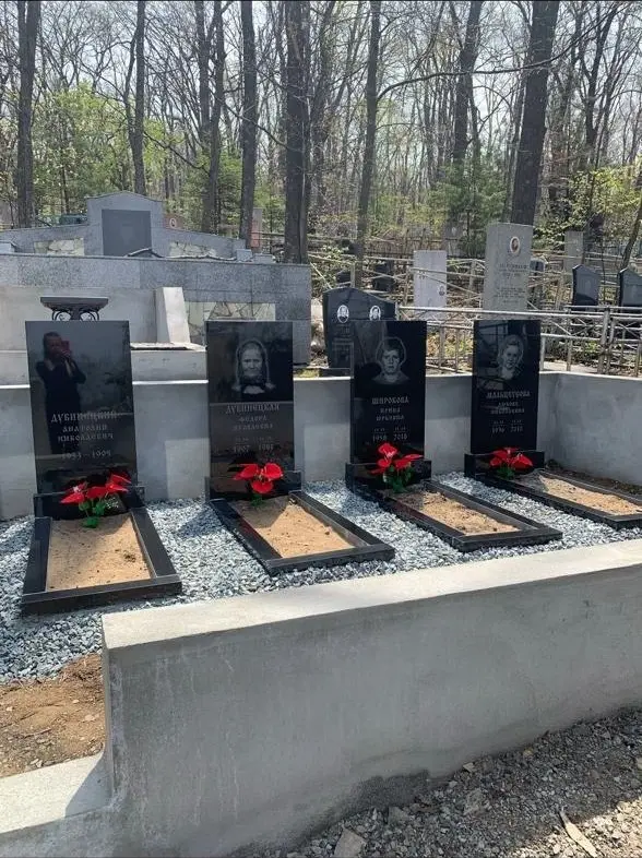 Общий вид участка с четырьмя памятниками, обрамлением могил и отсыпкой